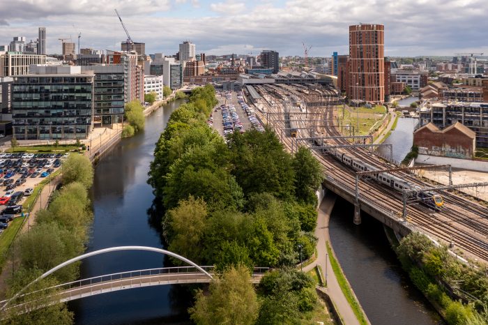 LEEDS,UK - MAY 12, 2022.  An aerial cityscape of Leeds city centre with train station and modern buildings along the Leeds to Liverpool canal